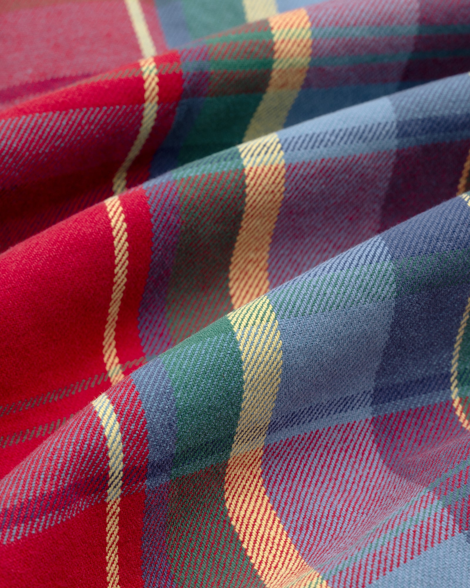 Close-up of the Plaid Work Shirt’s colorful red, blue, green, and yellow stripes with soft woven texture.