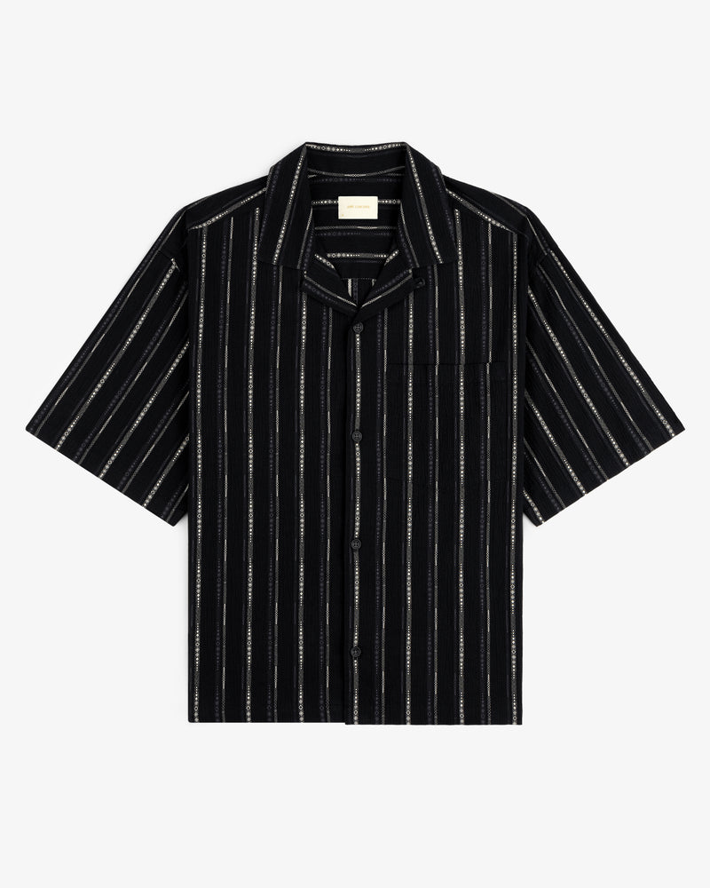Cropped Jacquard Camp Shirt in black with white vertical stripes, chest pocket, and short sleeves, laid flat.