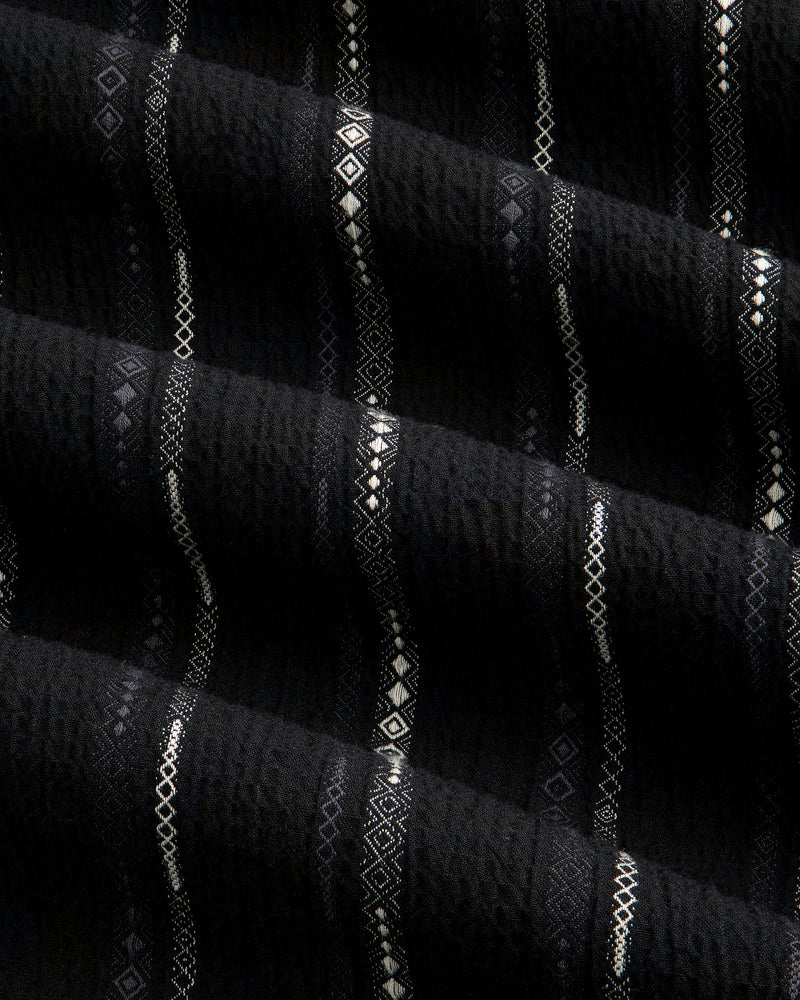 Close-up of black Cropped Jacquard Camp Shirt featuring vertical stripes and geometric patterns in white and gray.