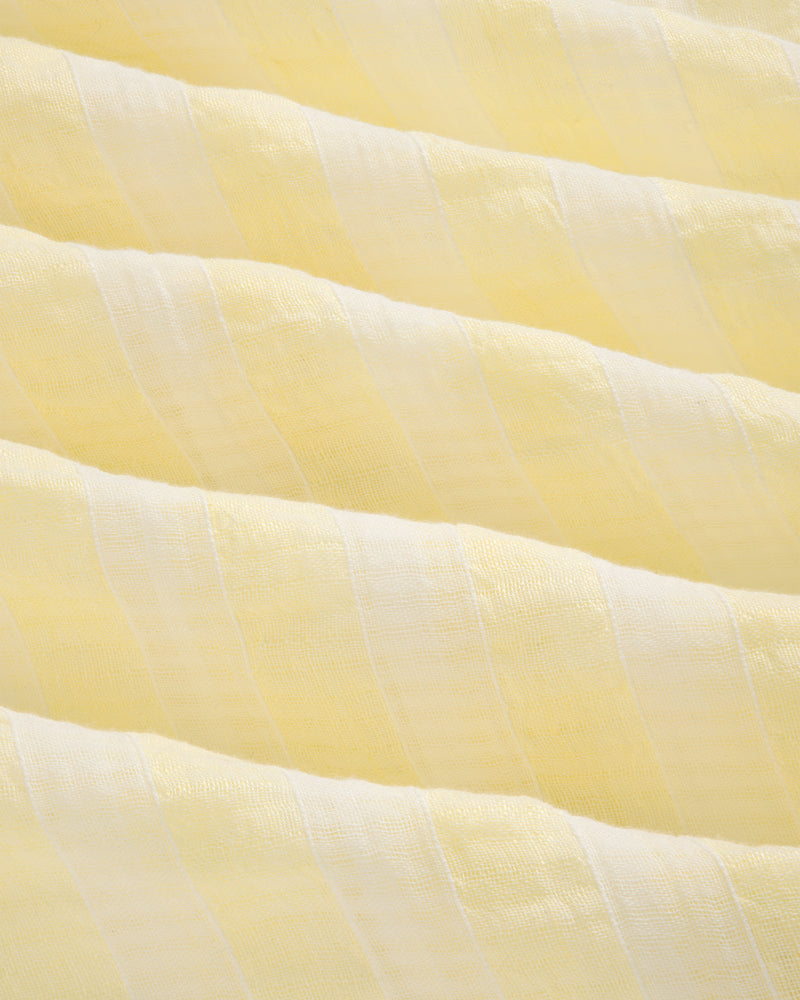 Close-up of the Linen Blend Striped Camp Shirt featuring light yellow and white stripes with a soft, textured surface.