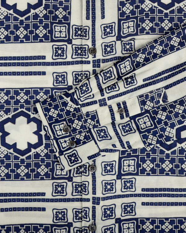 Close-up of the Mosaic Button Down Shirt with blue and white geometric patterns, buttons, and a folded cuff.