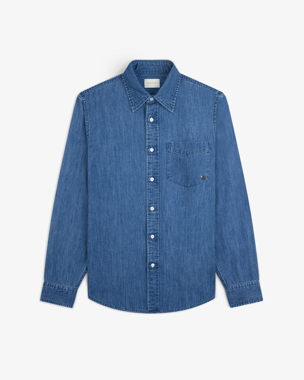 Crest Chambray Shirt: long-sleeve blue denim button-up with front chest pocket, laid flat on white background.