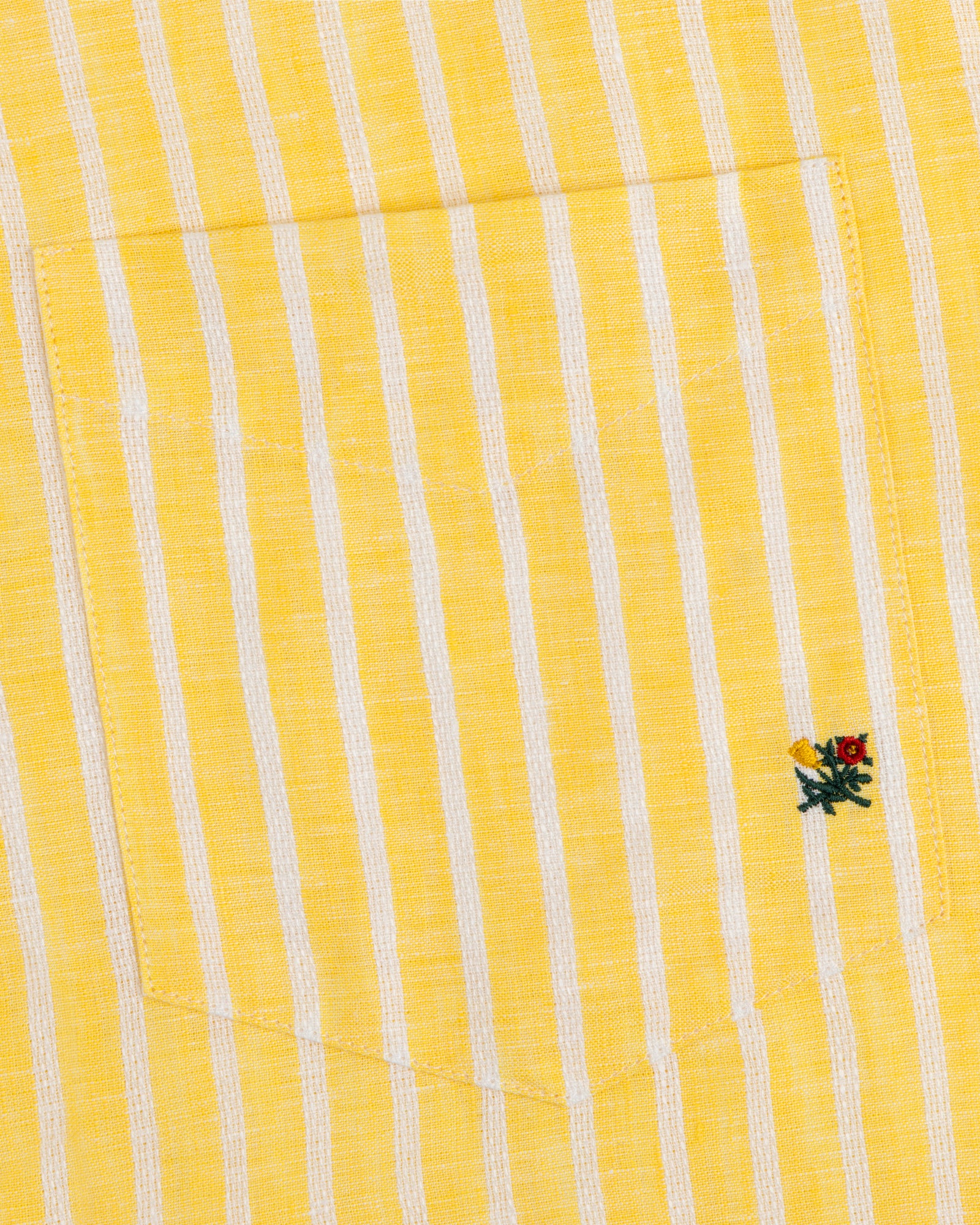 Striped Linen Casual Shirt with yellow and white stripes and a small embroidered flower by the pocket.