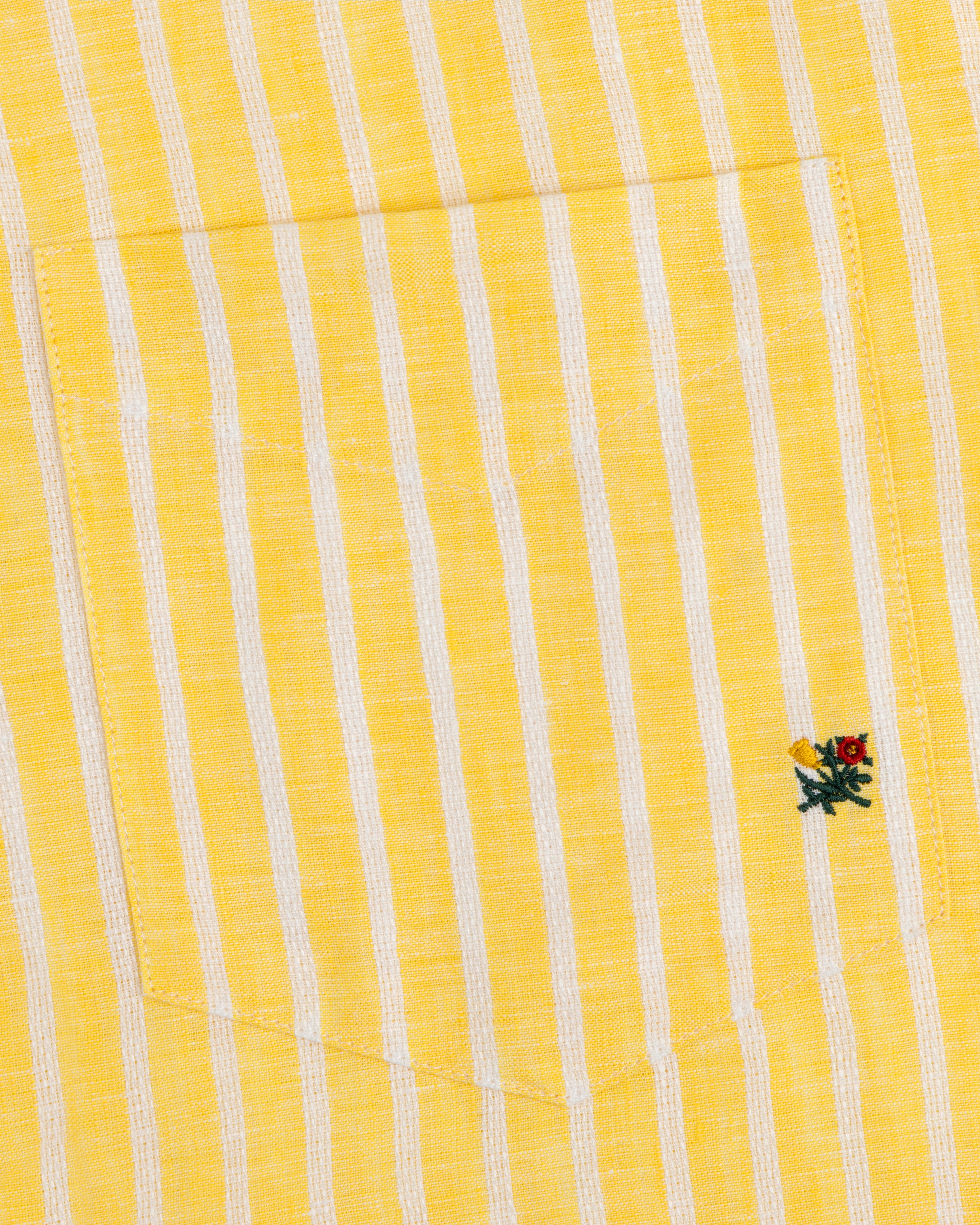 Striped Linen Casual Shirt with yellow and white stripes and a small embroidered flower by the pocket.