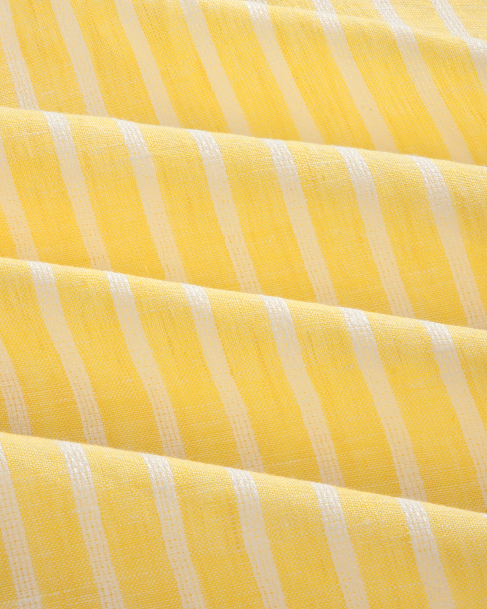 Striped Linen Casual Shirt in yellow and white, featuring a textured woven surface and gentle diagonal folds.