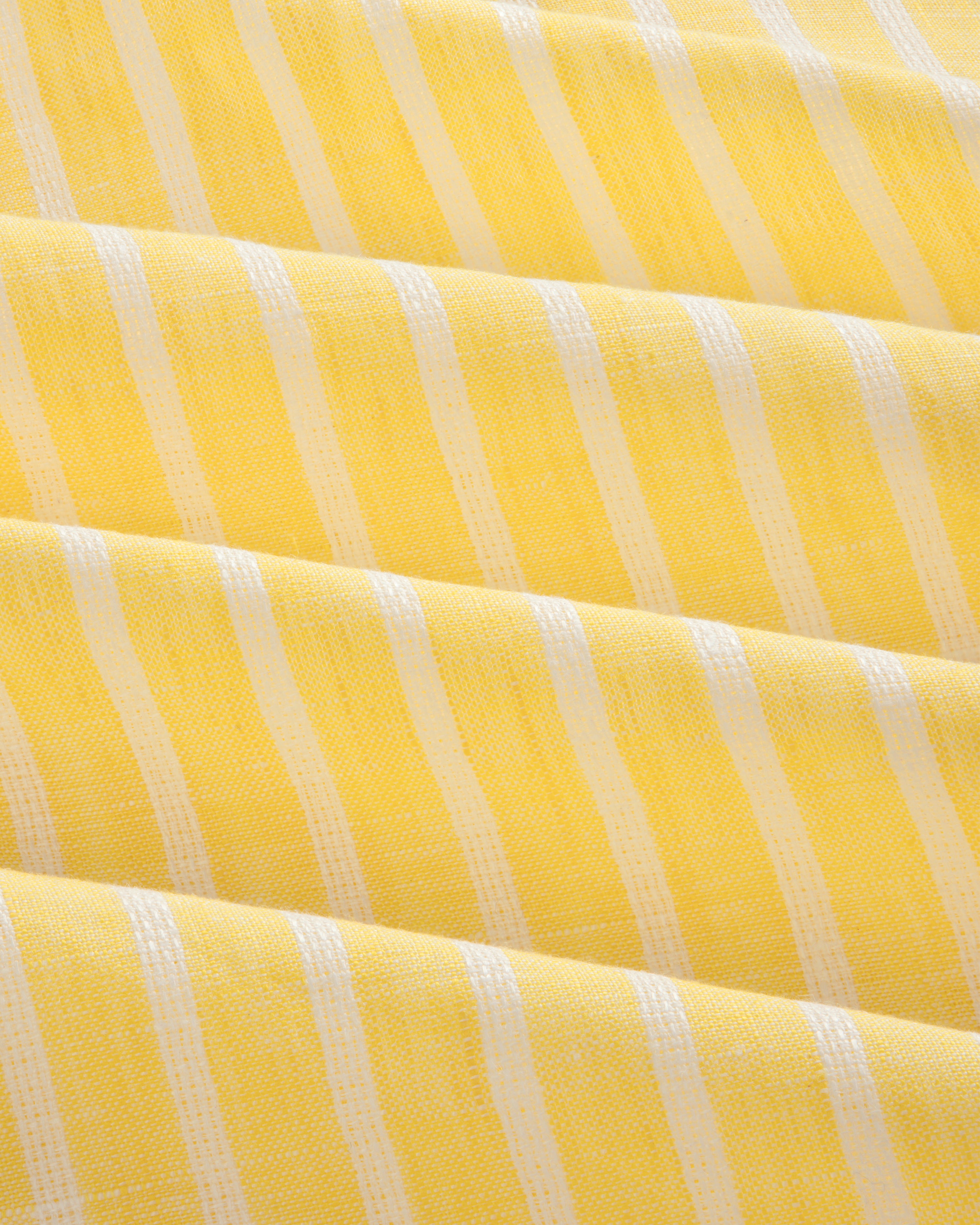 Striped Linen Casual Shirt in yellow and white, featuring a textured woven surface and gentle diagonal folds.