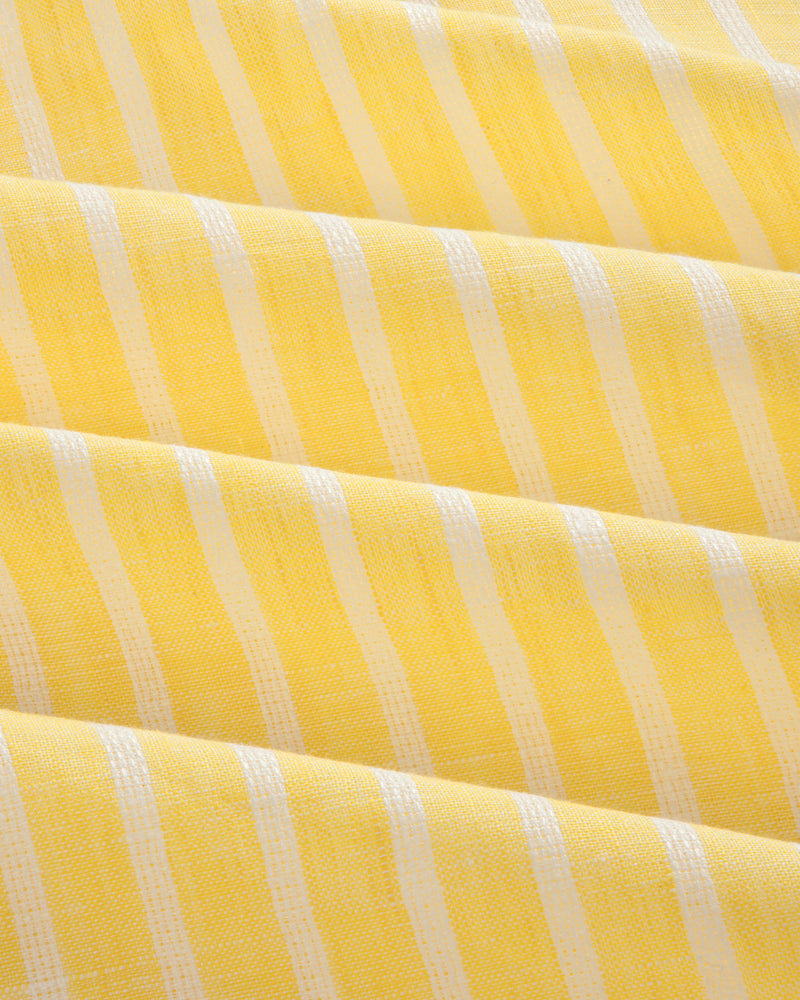 Striped Linen Casual Shirt in yellow and white, featuring a textured woven surface and gentle diagonal folds.