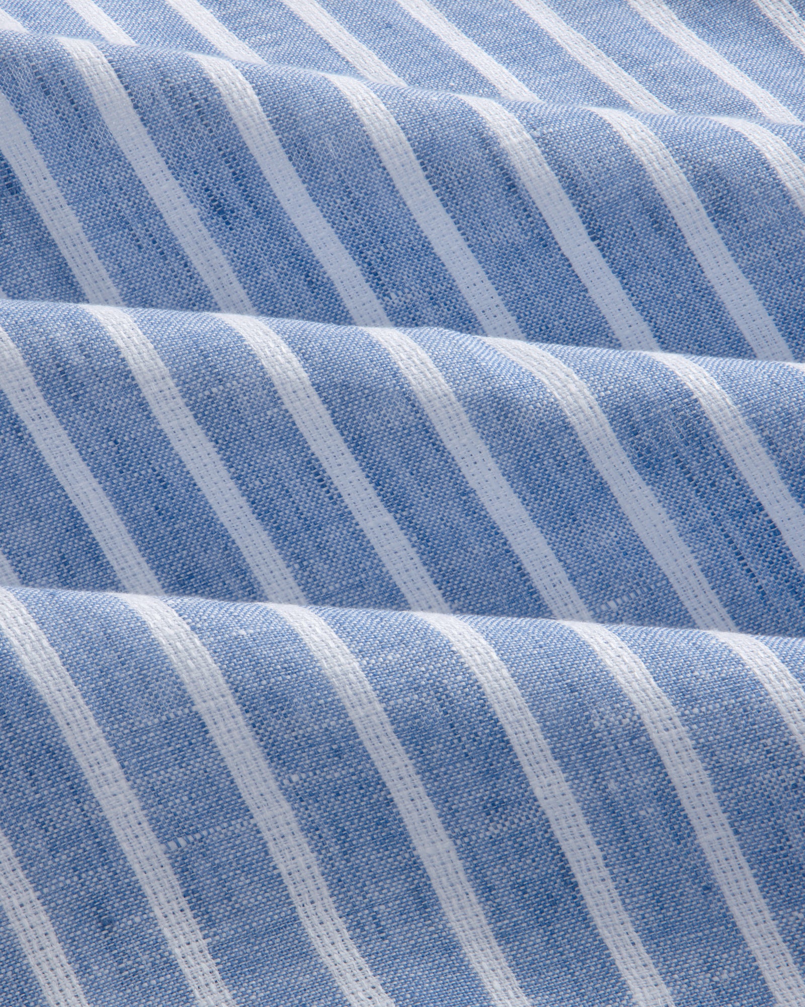 The Striped Linen Casual Shirt features blue and white stripes with soft waves and a textured look.