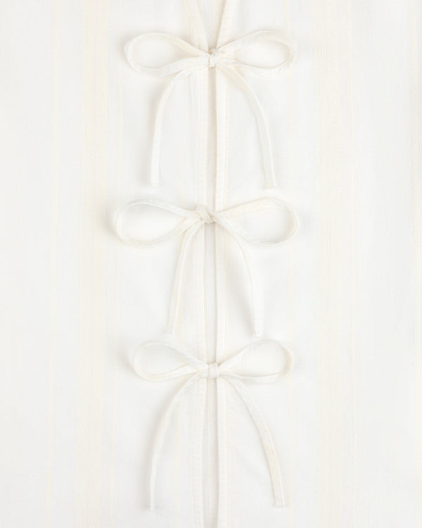 Jacquard Striped Tie-Front Shirt in white, featuring three fabric bows on a subtly striped background.