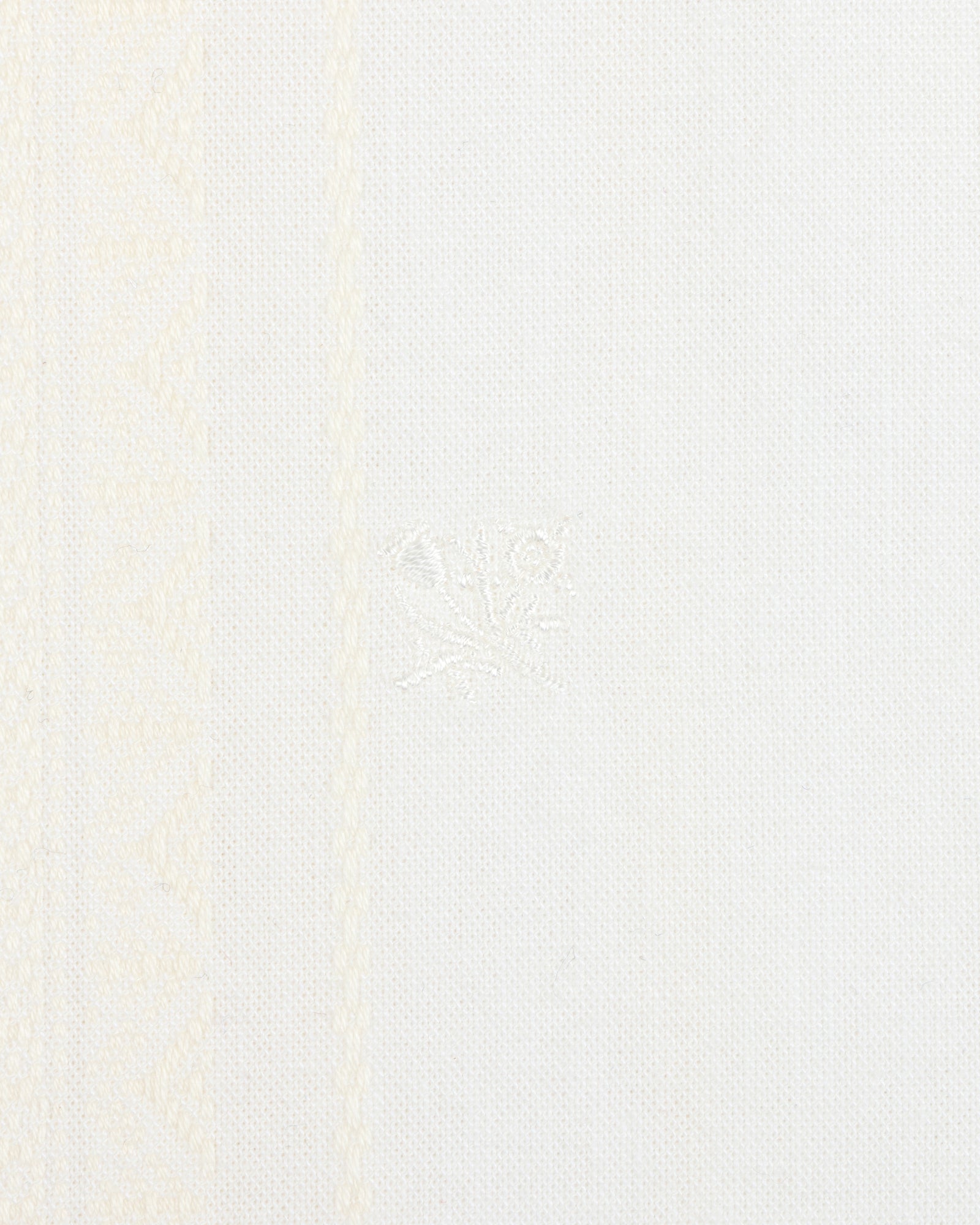 Close-up of the Jacquard Striped Tie-Front Shirt with white fabric and subtle woven geometric patterns on the left side.