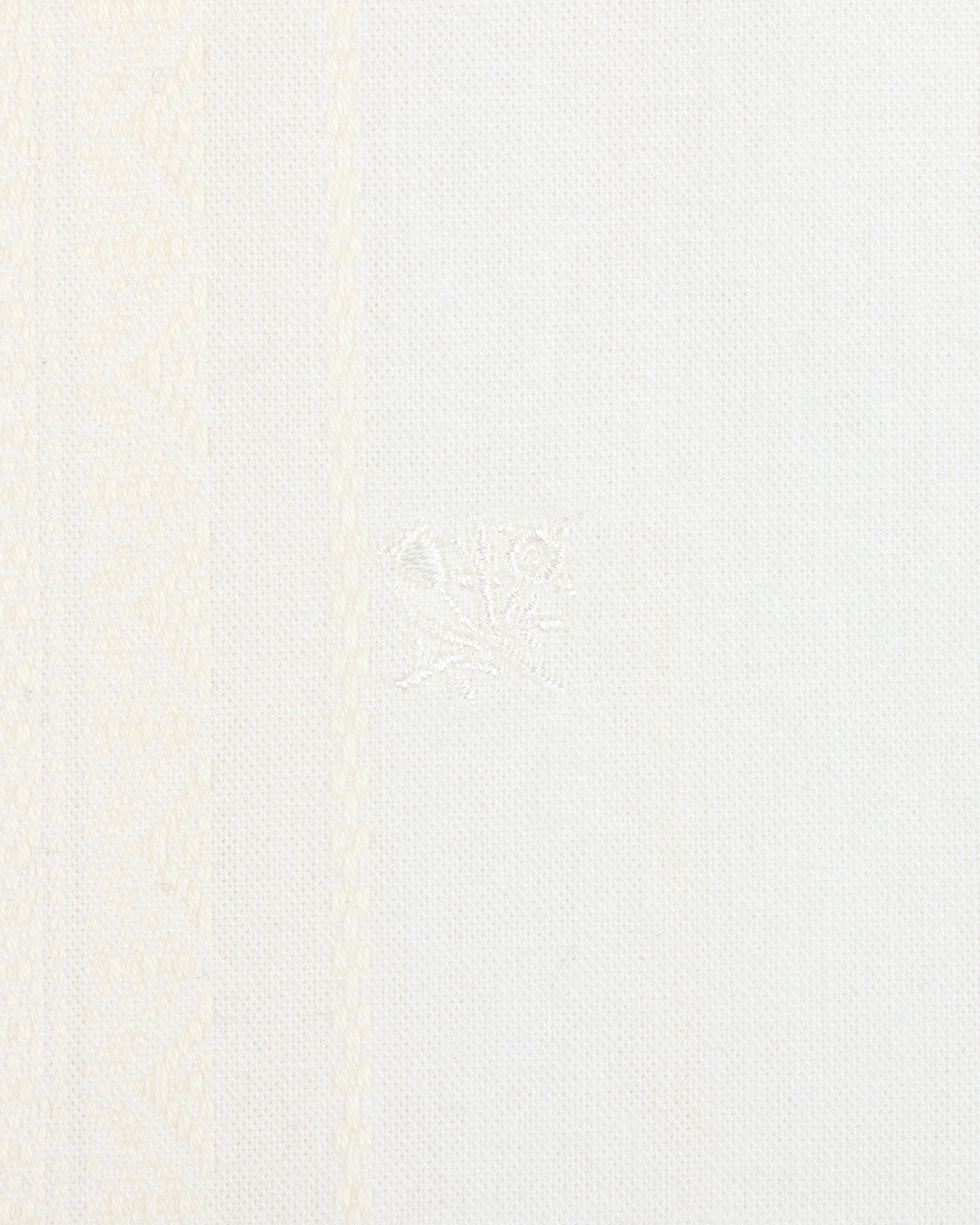 Close-up of the Jacquard Striped Tie-Front Shirt with white fabric and subtle woven geometric patterns on the left side.