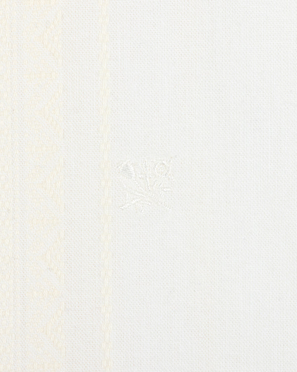 Close-up of the Jacquard Striped Tie-Front Shirt with white fabric and subtle woven geometric patterns on the left side.