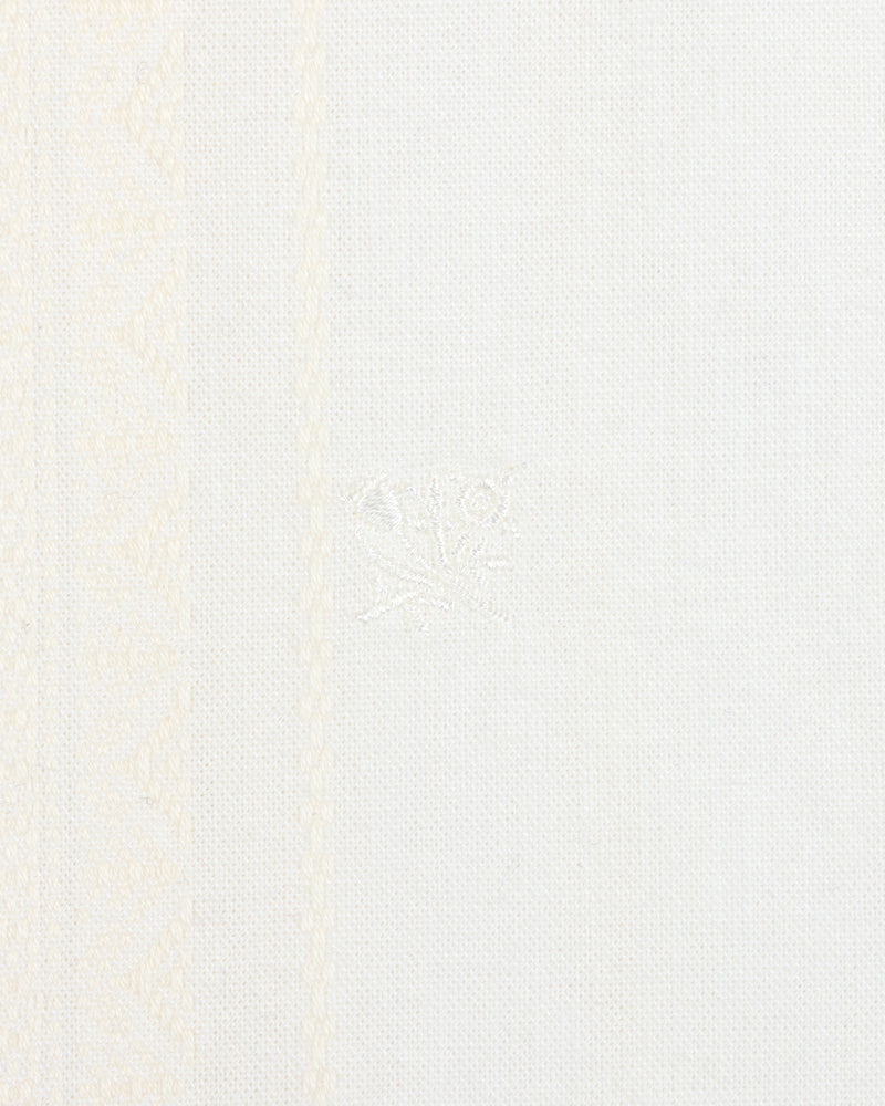 Close-up of the Jacquard Striped Tie-Front Shirt with white fabric and subtle woven geometric patterns on the left side.