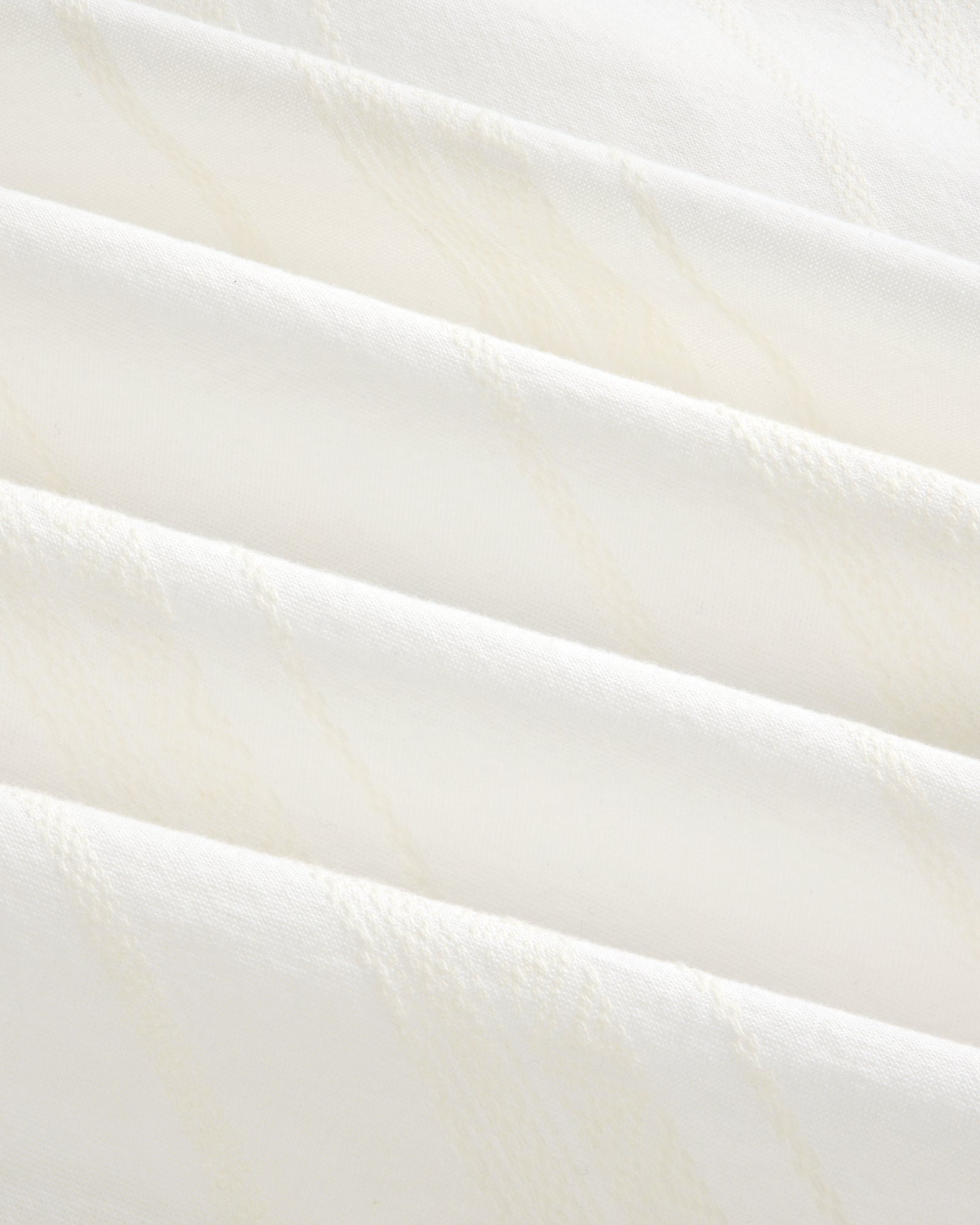 Close-up of the Jacquard Striped Tie-Front Shirt’s soft white fabric with subtle diagonal textured lines.