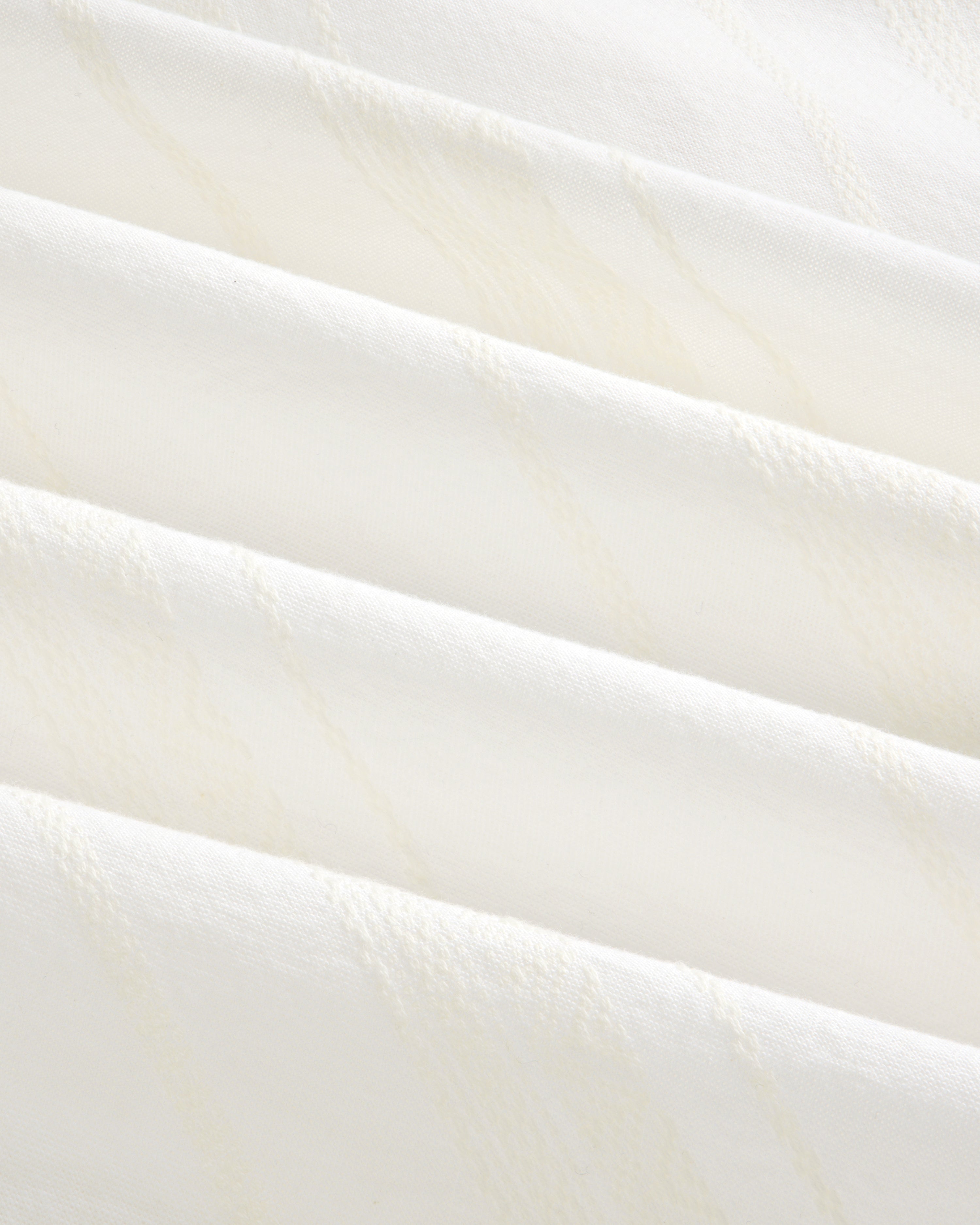 Close-up of the Jacquard Striped Tie-Front Shirt’s soft white fabric with subtle diagonal textured lines.