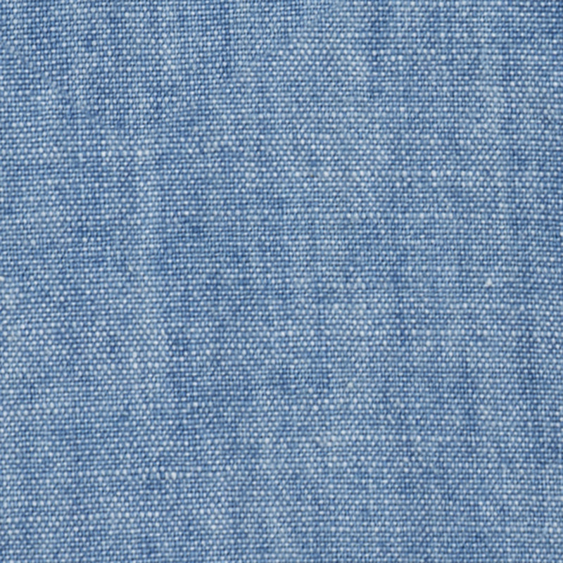 Close-up of Crest Chambray Shirt in light blue, highlighting woven threads and subtle color variations.