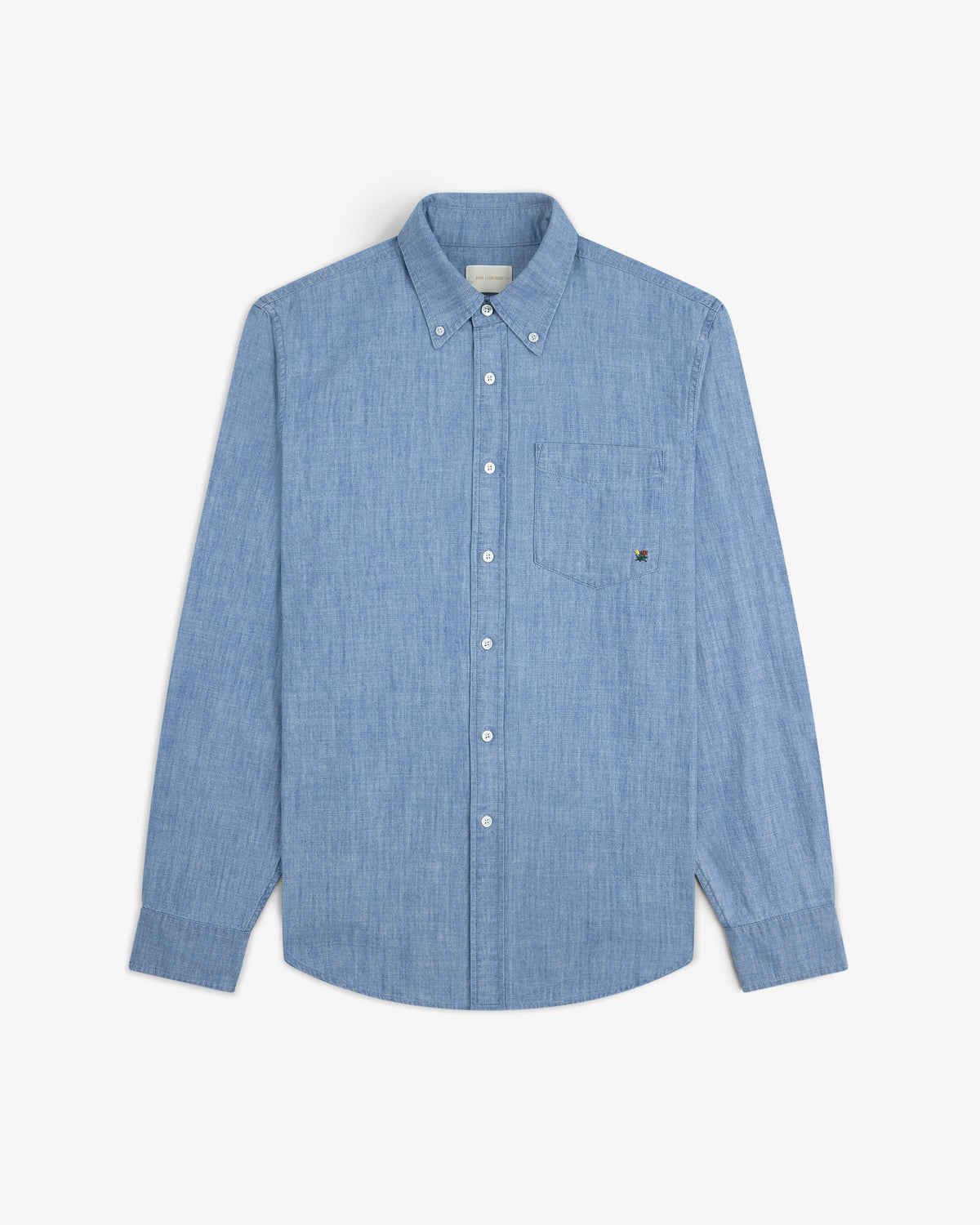 Crest Chambray Shirt: light blue long-sleeve button-up with chest pocket, shown on a white background.