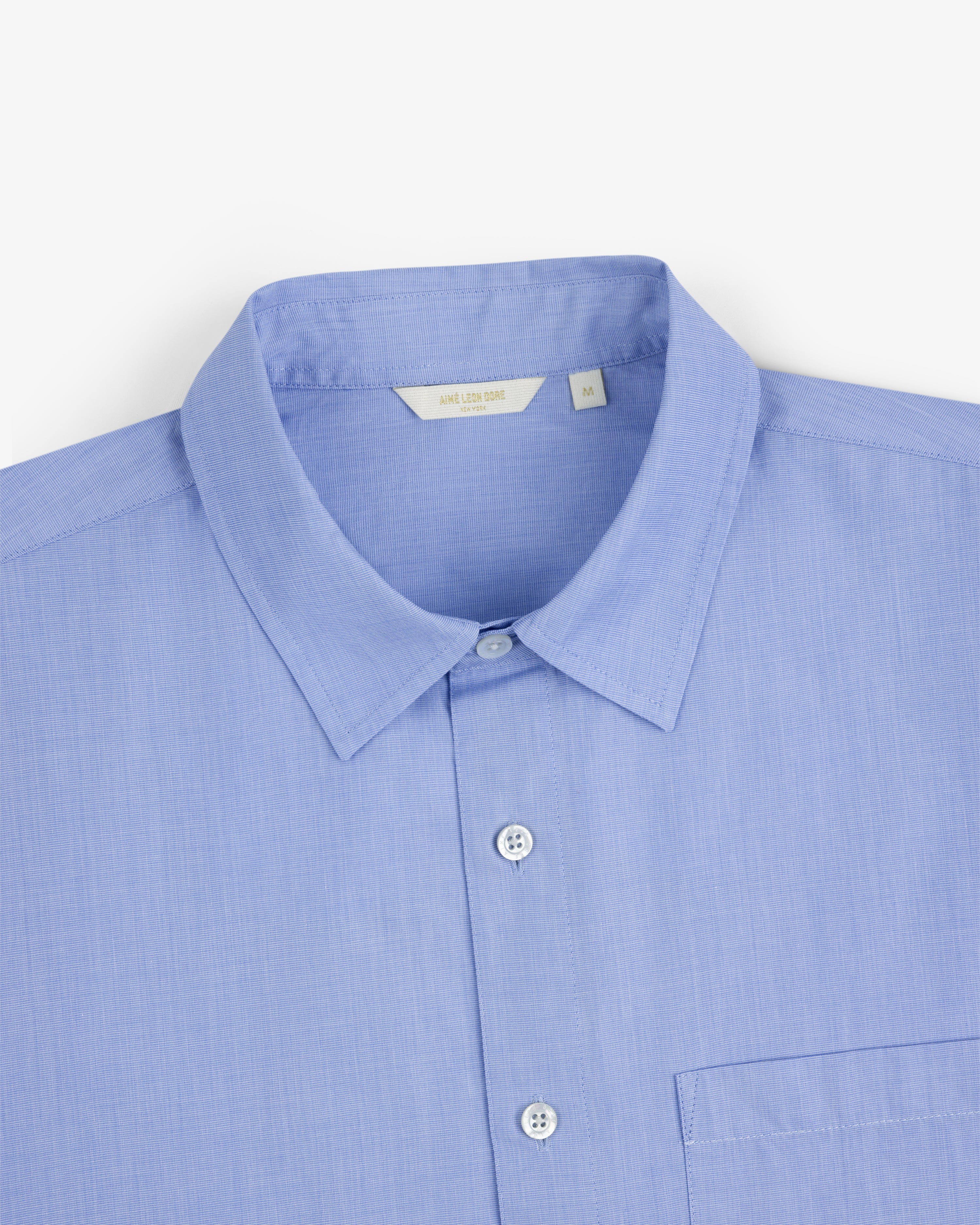 Poplin Casual Shirt in light blue with a pointed collar and chest pocket, shown on a white background.