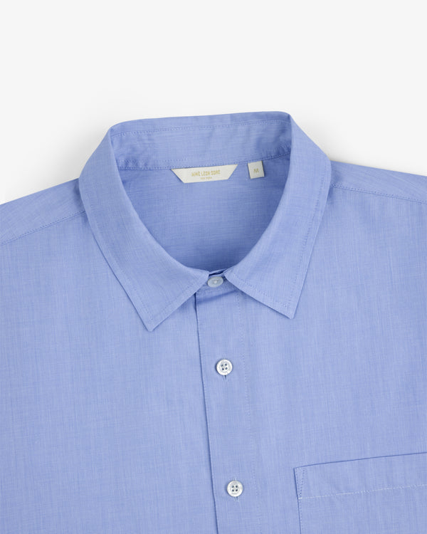Poplin Casual Shirt in light blue with a pointed collar and chest pocket, shown on a white background.