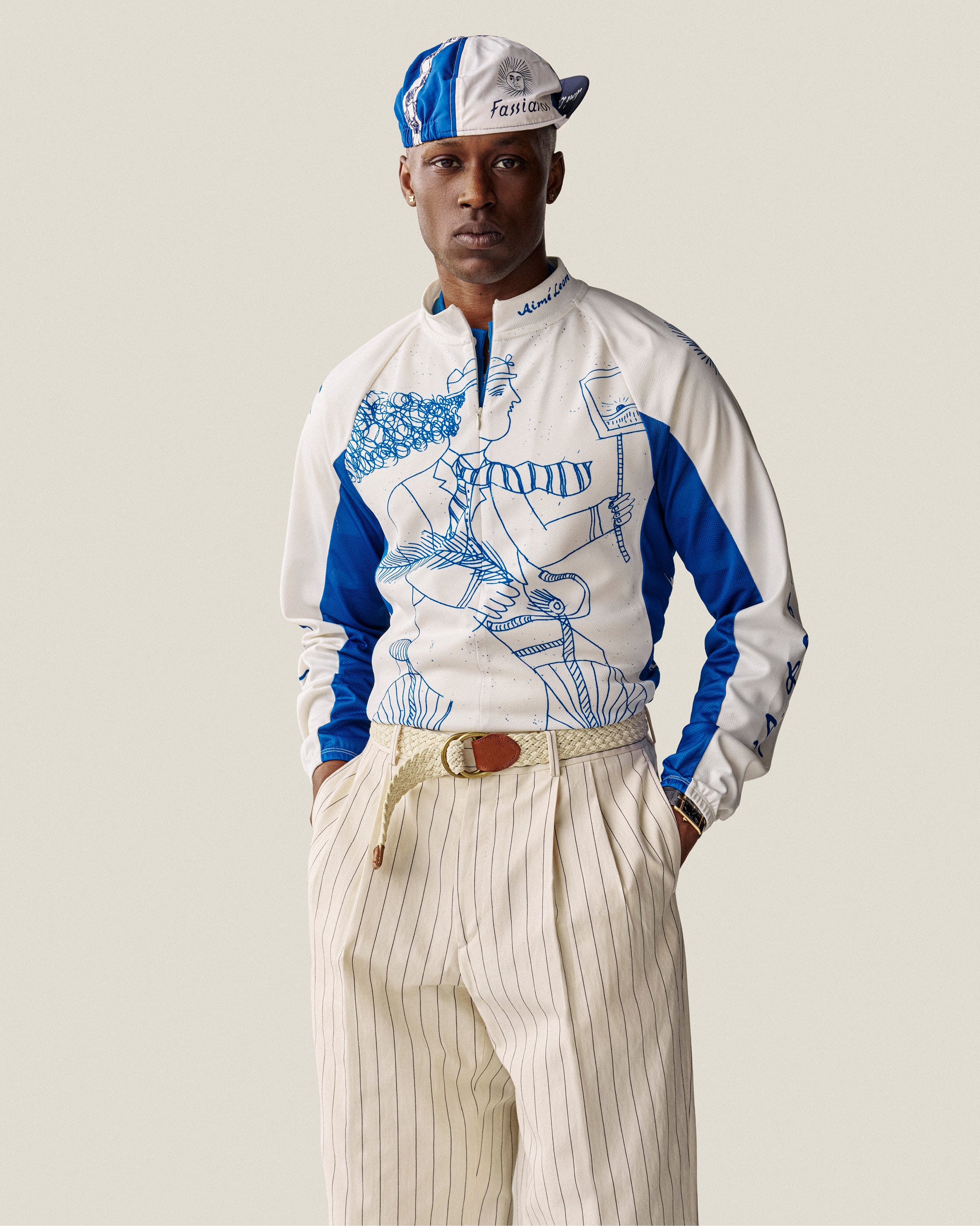 Man in Fassianos Half-Zip Cycling Jersey and pleated pinstripe trousers, hands in pockets.
