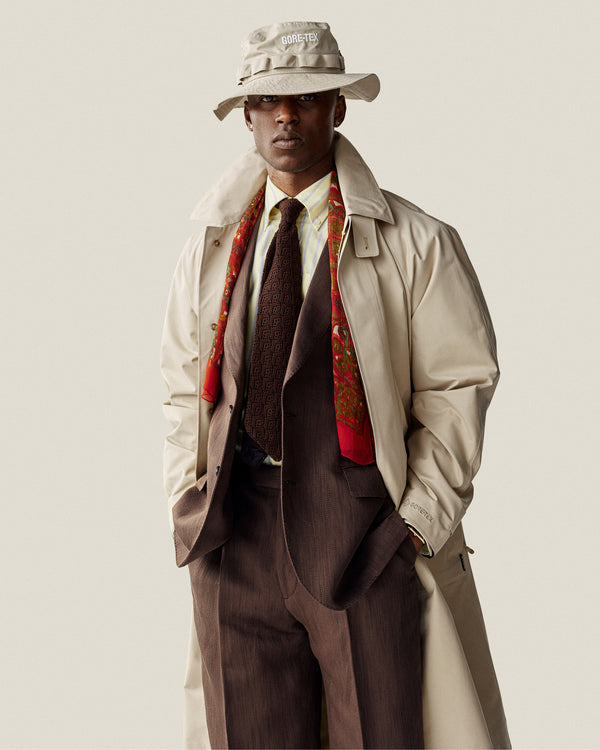 A man in a Yarn Dyed Striped Crest Shirt stands against a plain background.