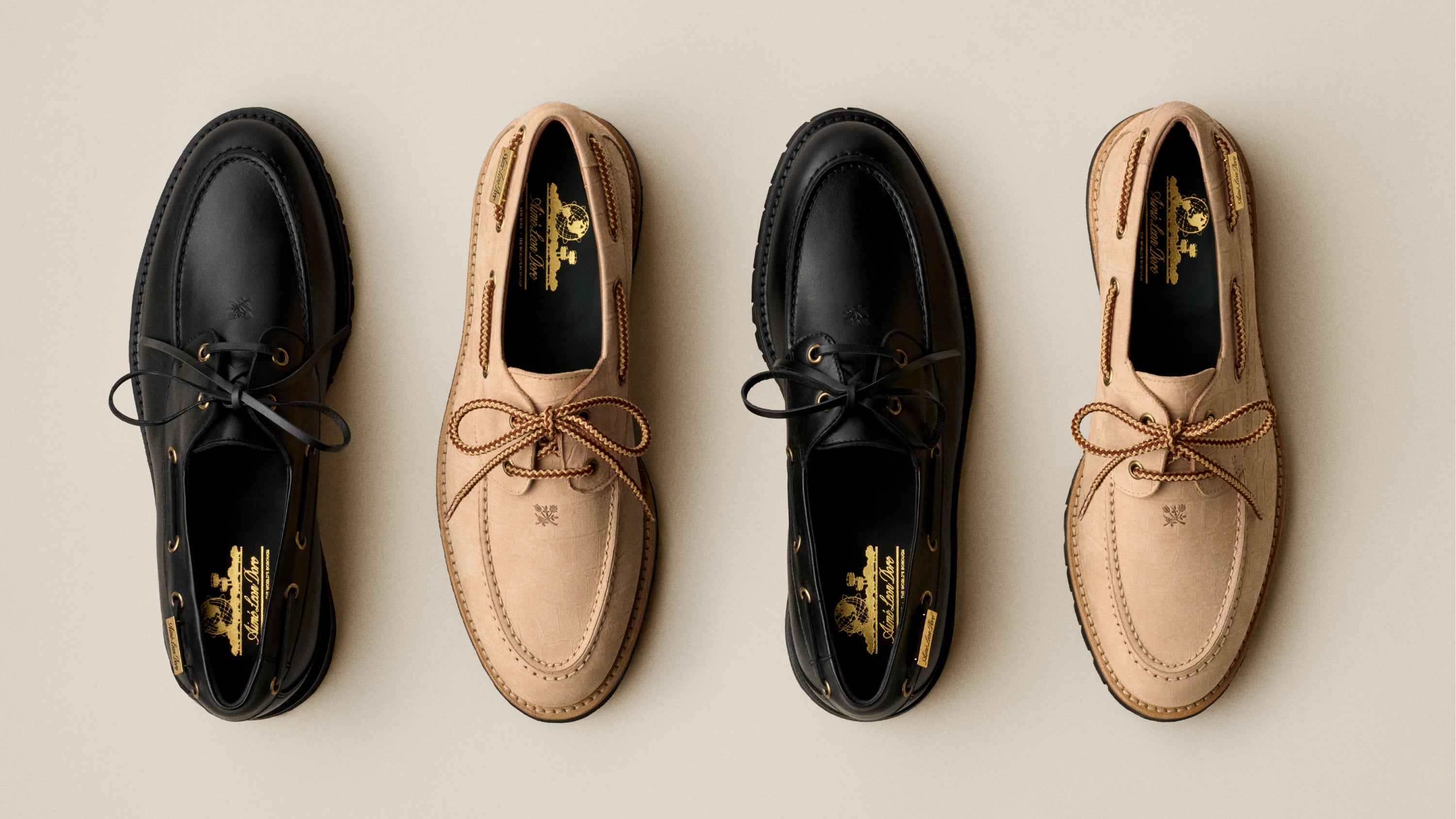 Two pairs of black and beige leather shoes on a light background