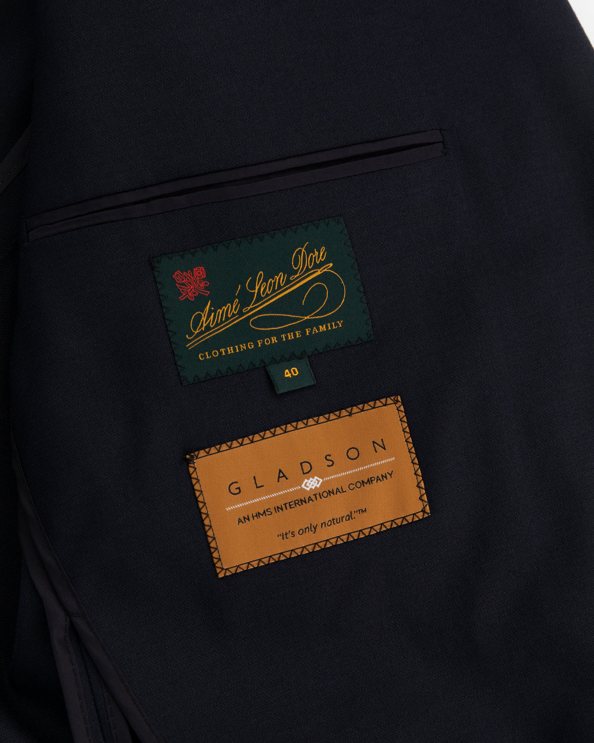 Close-up of Tropical Wool Suit Jacket lining showing Aimé Leon Dore, Gladson labels, text, and size 40 tag.