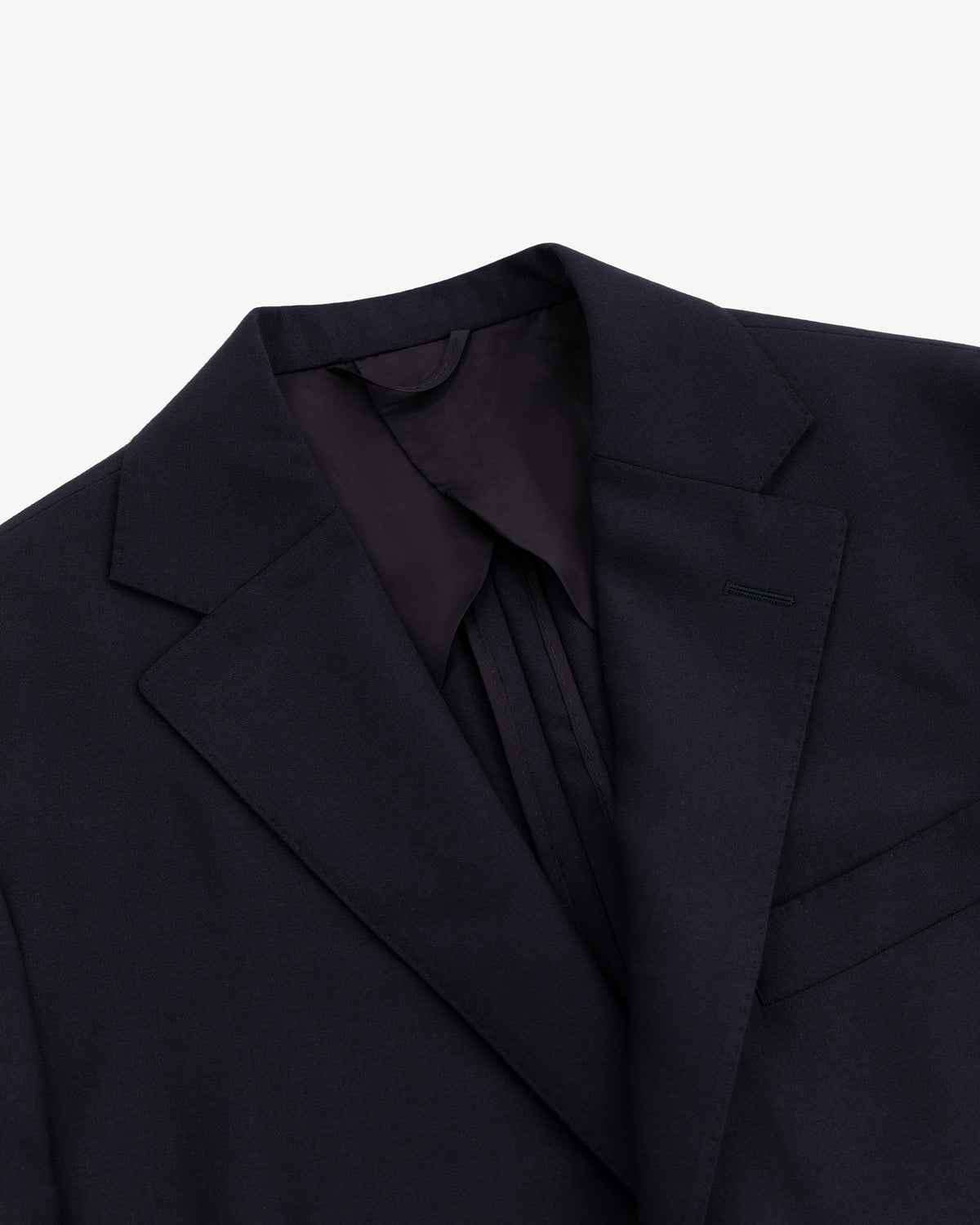 Close-up of the Tropical Wool Suit Jacket featuring a notched lapel and chest pocket on a white background.