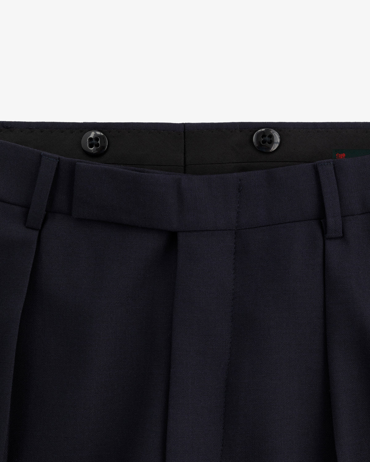 Close-up of the waistband and top front of Tropical Wool Suit Trouser in navy with belt loops and two black buttons.