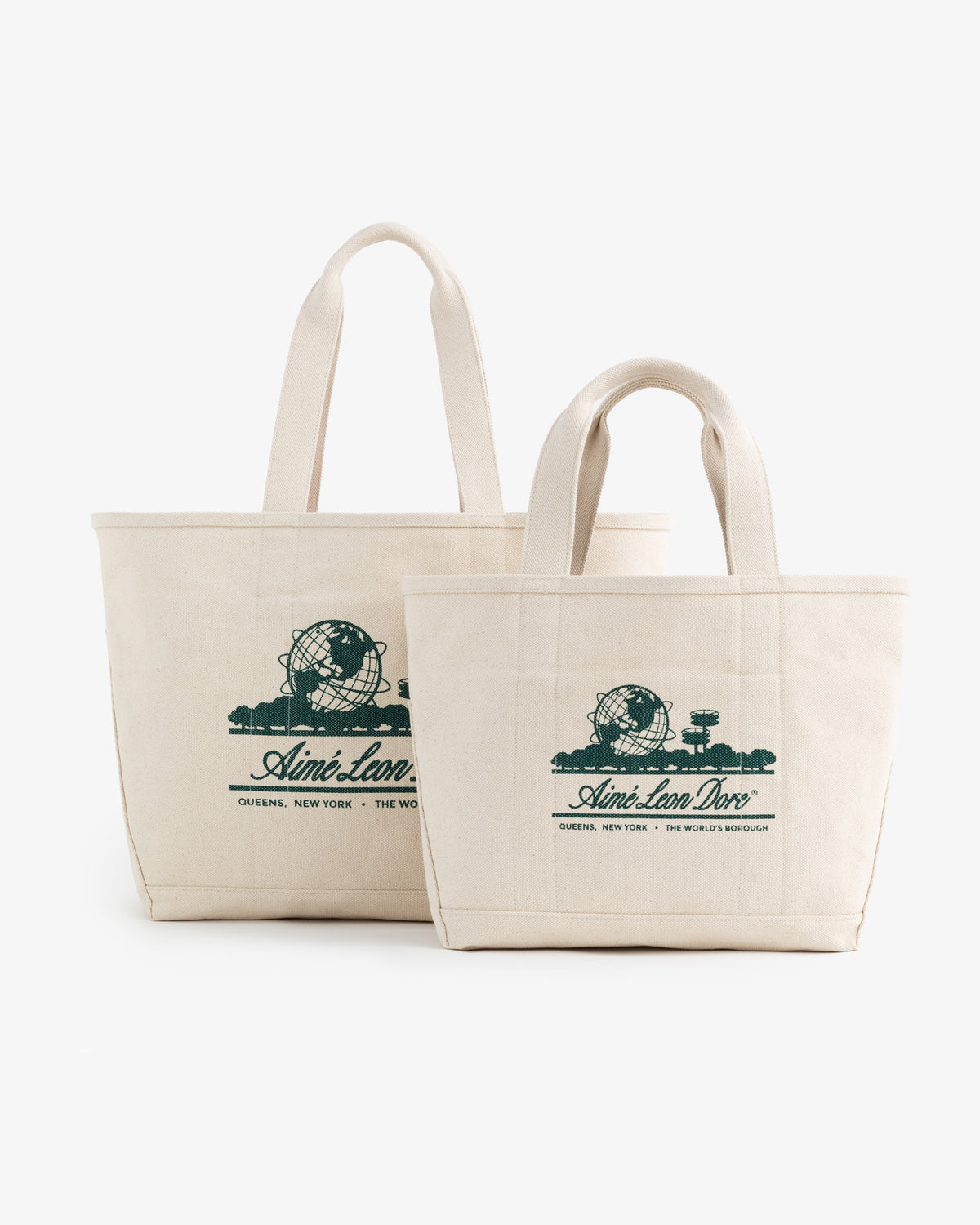 Two cream-colored Small Unisphere Tote Bags with green Aimé Leon Dore text and globe graphics.