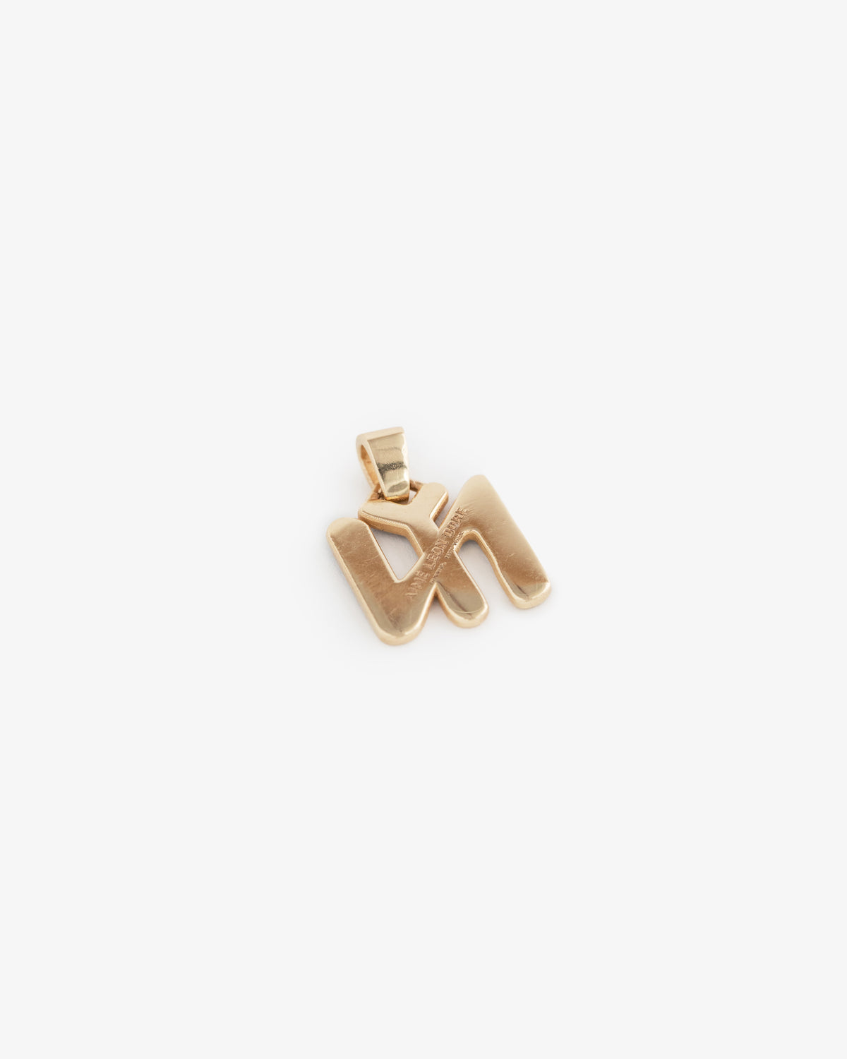 14Kt Gold Pendant shaped like the Hebrew letter shin on a white background.