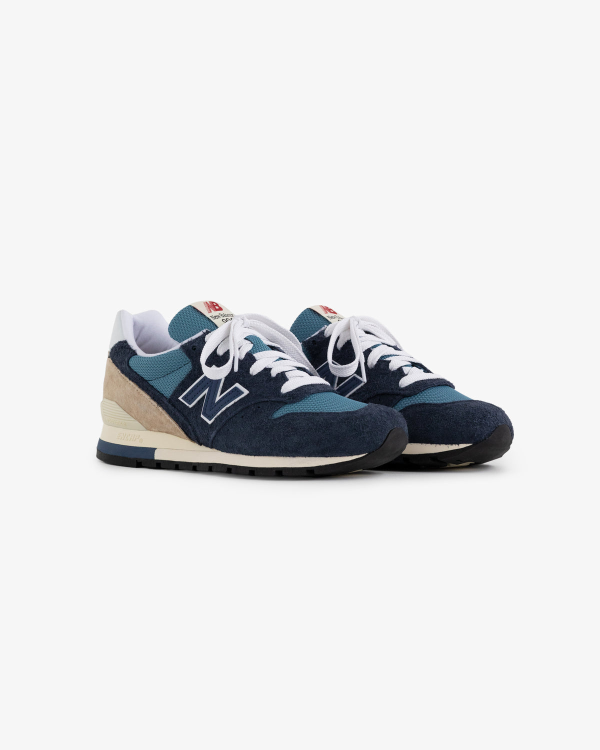 A pair of blue and beige New Balance Made in USA 996 sneakers with white laces on a white background.