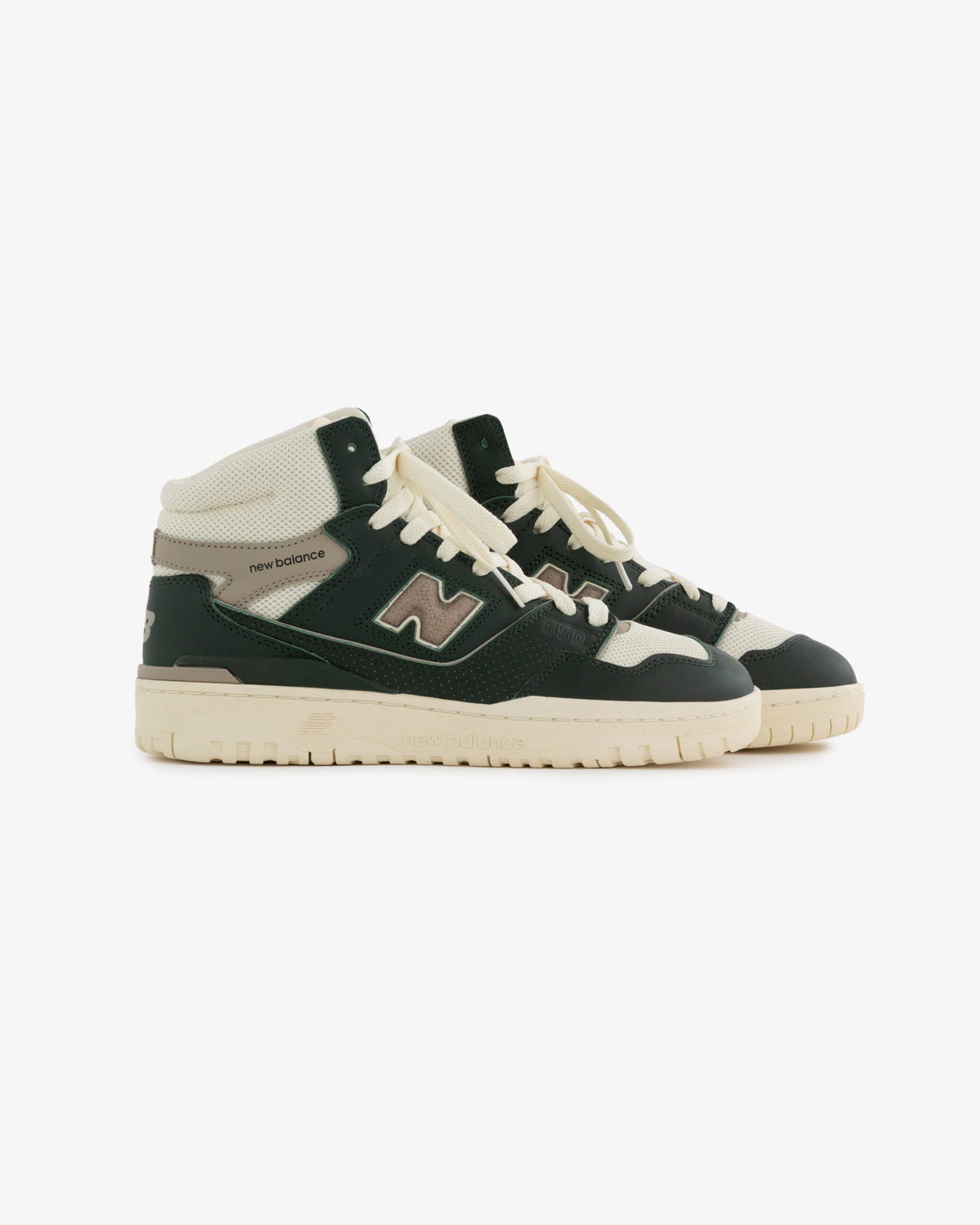 A pair of black, white, and cream ALD / New Balance 650R high-top sneakers with laces on a white background.