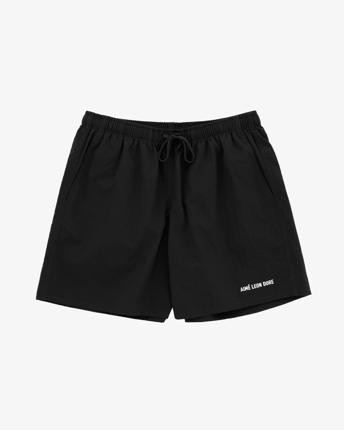 Logo Swim Short in black with side pockets and white AIMÉ LEON DORE text by the left hem, on a white background.