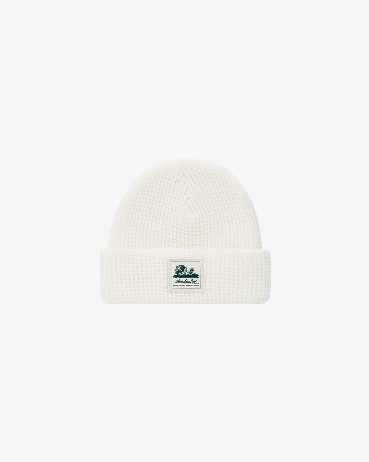 Waffle Knit Beanie in white with folded brim and small green and white logo patch on the front.