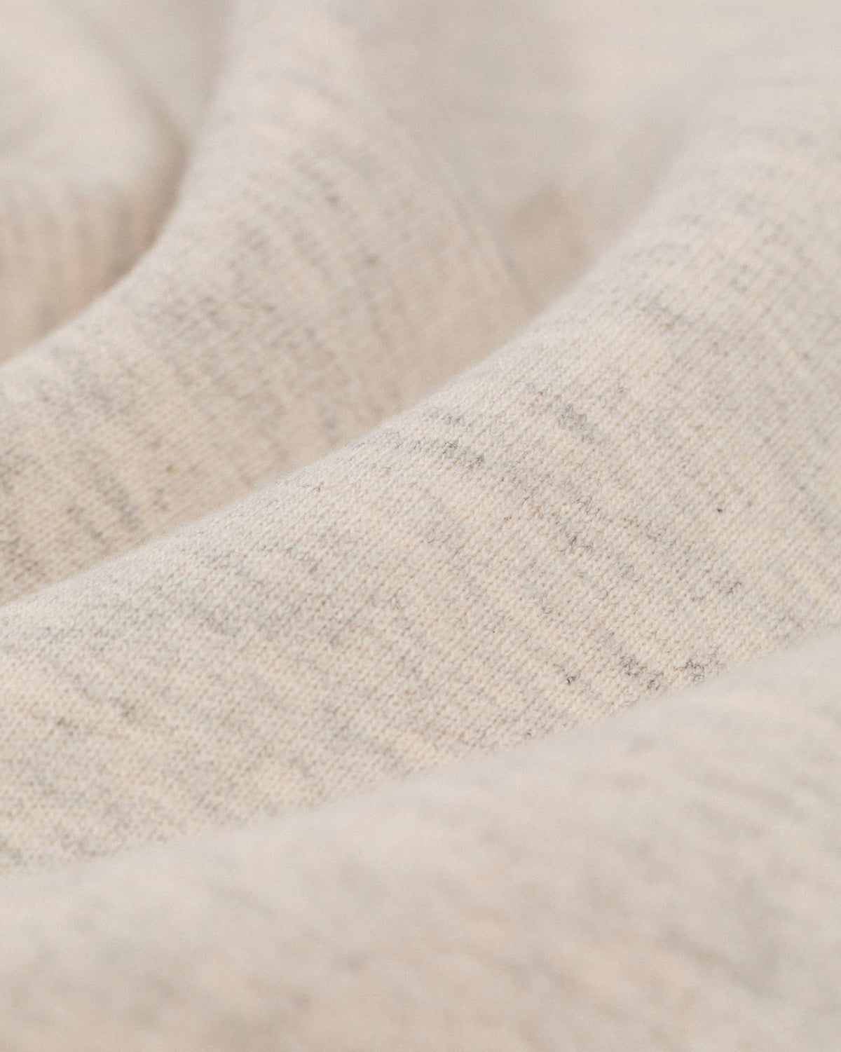 Close-up of Tonal Logo Sweatshorts in soft, light beige fabric with visible texture and gentle folds.